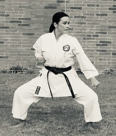 Senpai Crystal Villagran, 4th Dan martial arts instructor, smiling in a traditional white karate gi at Karate of LA.