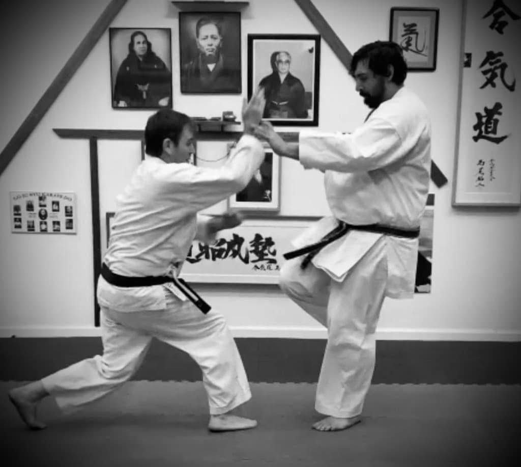 adult-kumite-sparring-karate-classes-west-la Two adult black belt students practicing controlled sparring drills and partner application techniques during a Kumite class at Karate of LA.