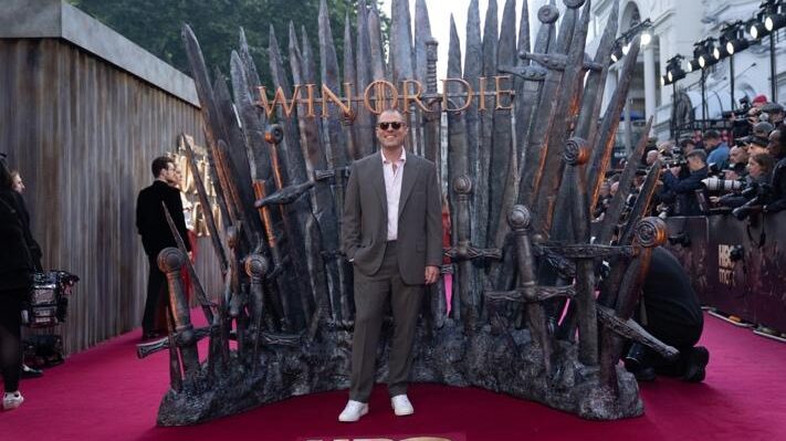 House of the Dragon creator Ryan Condal on the red carpet in front of the Iron Throne at the London premiere.