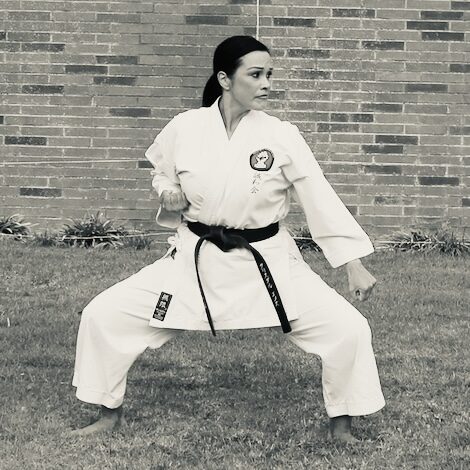 Senpai Crystal Villagran, 4th Dan Goju-Ryu karate instructor at Karate of LA, performing a traditional low stance kata.