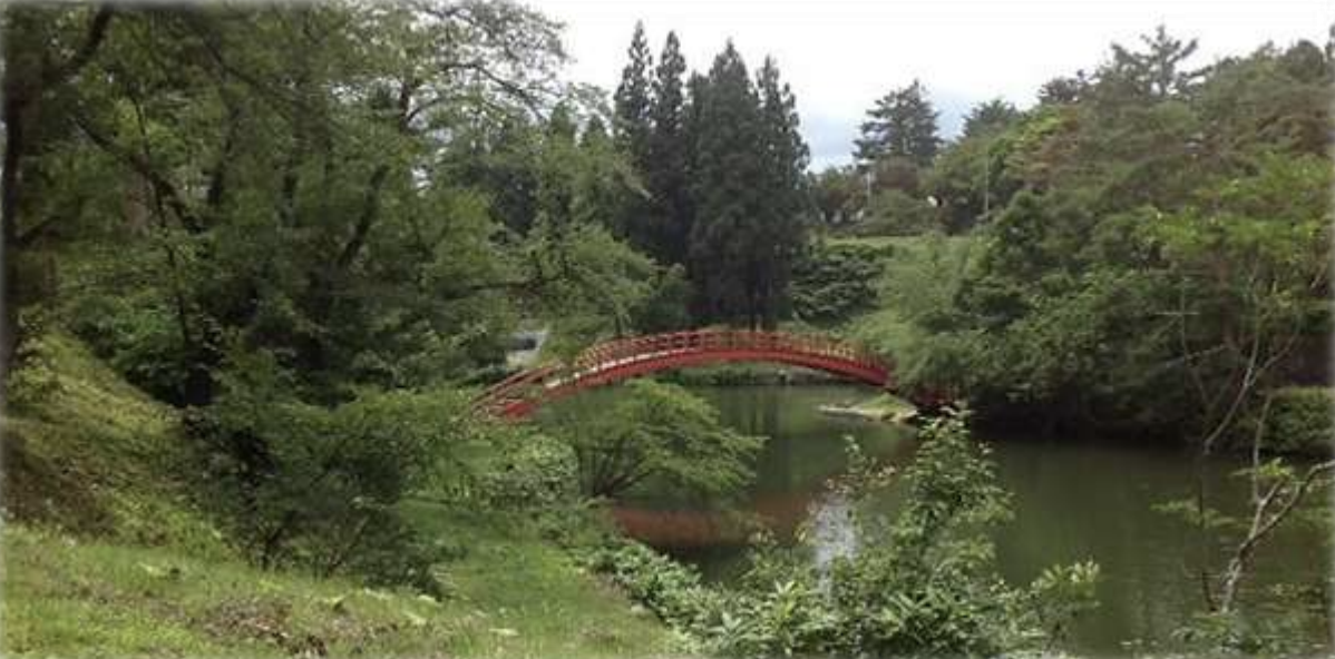 Seiwa-Kai Newsletter Issue 7 Cover Artwork - Photograph of a Red Bridge over a River Surrounded by Greenery