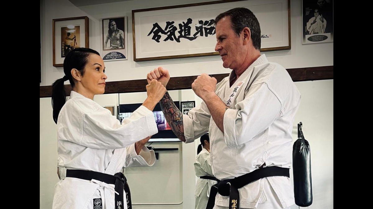 Senpai Crystal and Senpai Mike practicing traditional Goju-Ryu karate together on the dojo mat at Karate of LA in West Los Angeles.