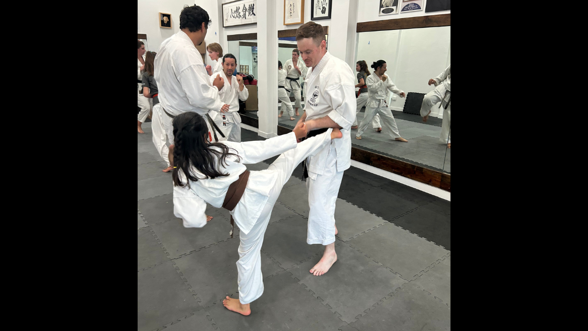 Confident youth karate student practicing a self-defense kick at Karate of LA in West Los Angeles.