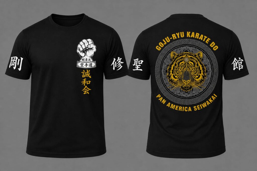 Image showing the front and back of the official t-shirt of the 2026 Pan American Seminar. It is a black t-shirt with a Goju-Ryu fist emblem on the front and a tiger on the back.